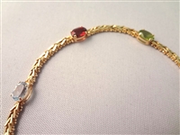 14K Gold Multi Gemstone Tennis Bracelet: (5) Oval Garnet, Amethyst, Peridot, Topaz, Citrine