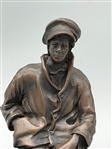 De La Poer Figurine Bronze Man Seated on a Log