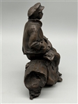 De La Poer Figurine Bronze Man Seated on a Log